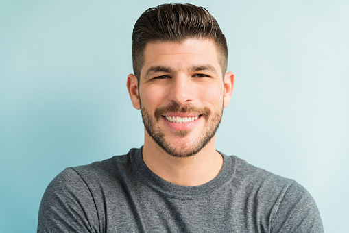 Portrait of attractive Hispanic male smiling in studio