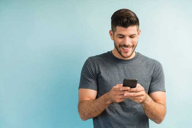 istock Attractive Hispanic Male Surfing On Mobile Phone 1182053599
