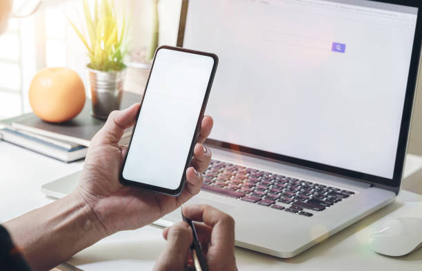 istock Man sitting at office desk and using the mobile smartphone. 1182053678