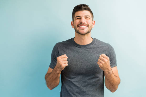 istock Handsome Latin Man Smiling In Excitement Against Turquoise Background 1182054839