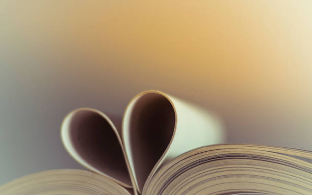 istock Open book of shape of heart 1182055070