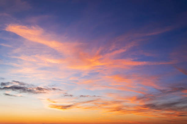 istock Beautiful orange clouds on a golden blue sky during sunset. Scenic sundown cloudscape for background. Afterglow of sunset. 1182061112