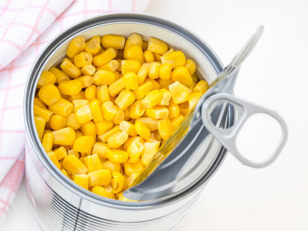 istock Canned sweet corn in a tin can with pull tab on a table. Side dish and ingredient for salads. Vegetarian food. 1182061176