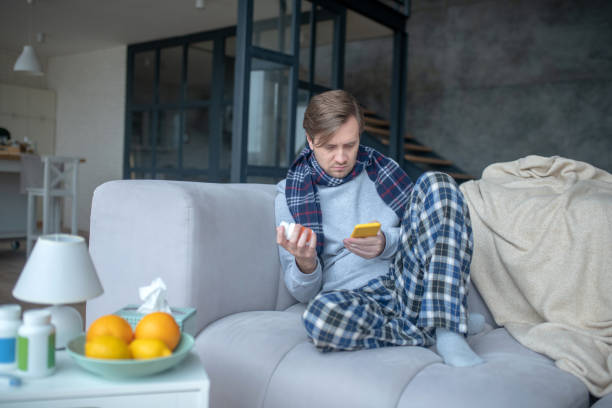 istock Man taking his smartphone while texting doctor online 1182061712