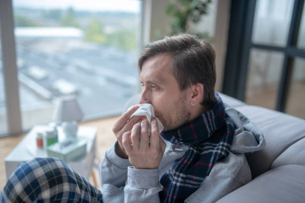 istock Bearded man holding napkin while having stuffy nose 1182063157