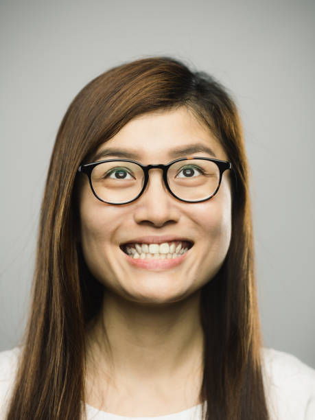 istock Real chinese young woman with happy expression looking up 1182063226