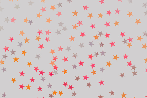 Star design wallpaper or wrapping paper style design with pastel coloured star pattern