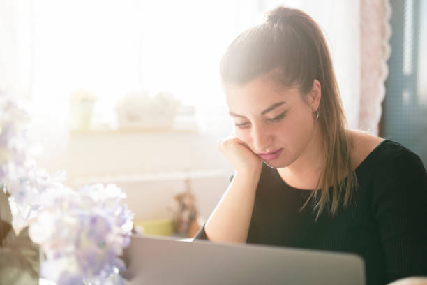 istock Tired girl working on her laptop 1182065857