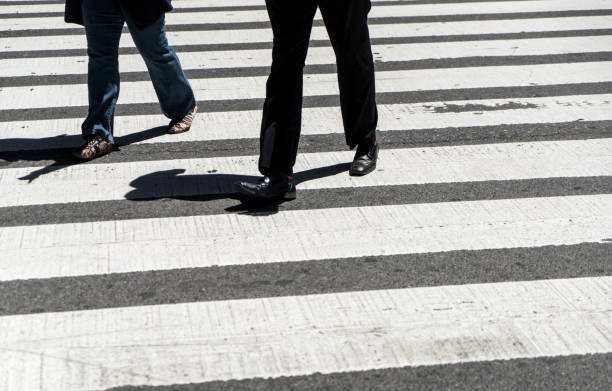 istock Pedestrians crossing at intersection, New York City 1182068676