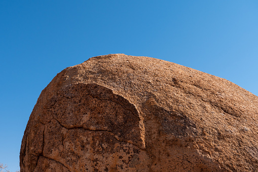 Round Red Granite Rock against Blue Sky Background, Erongo Mountains, Namibia, Africa