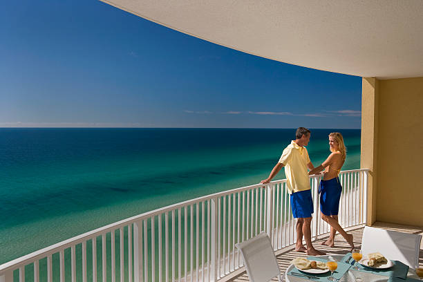 istock Couple Standing On Balcony Overlooking Ocean 118207333
