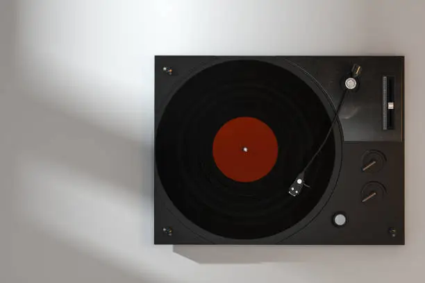 Photo of The dark vinyl record player on the table, 3d rendering.