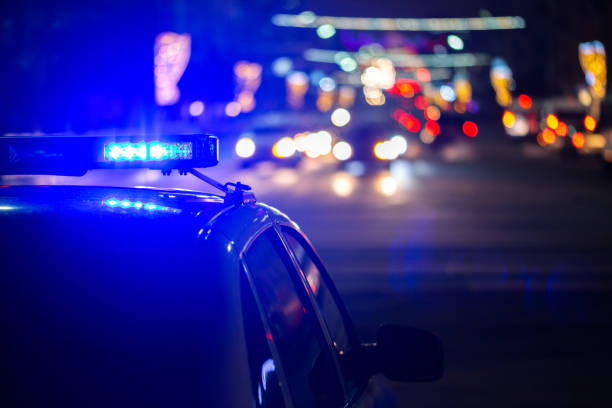 police car lights at night in city with selective focus and bokeh police car lights at night in city with selective focus and bokeh. police vehicle lighting photos stock pictures, royalty-free photos & images