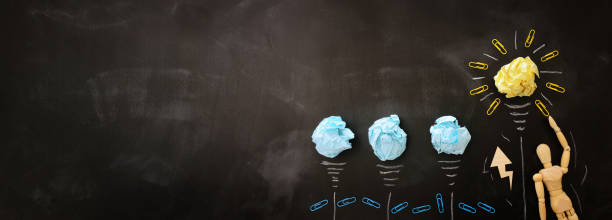 istock Education concept image. Creative idea and innovation. Crumpled paper as light bulb metaphor over blackboard 1182077228