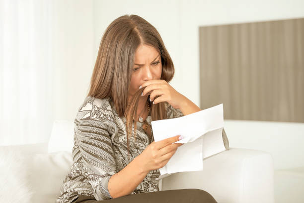 istock Business woman reading a document in office workspace. 1182077347