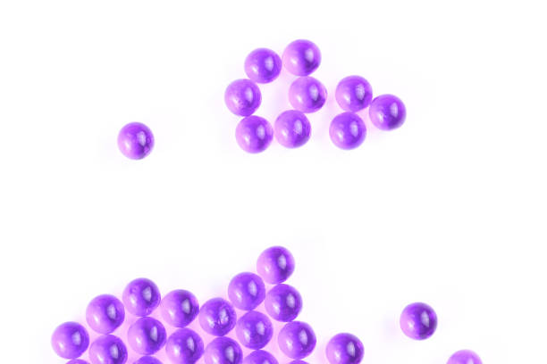istock proton purple spherical ball capsules with selective focus isolated on white background 1182081692