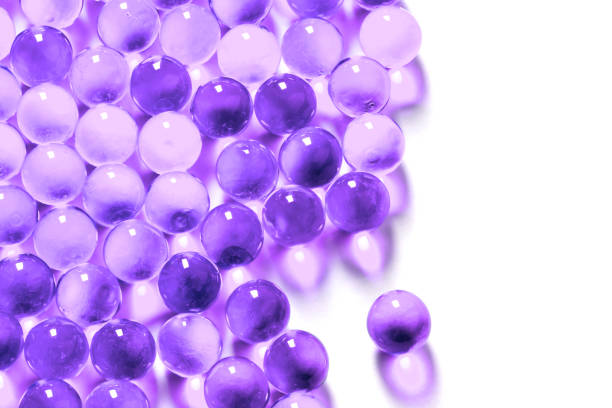 istock proton purple spherical ball capsules with selective focus isolated on white background 1182081709