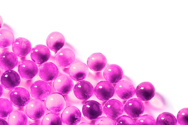 istock plastic pink spherical ball capsules with selective focus isolated on white background 1182081722