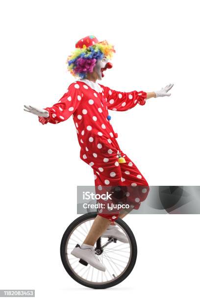 Cheerful Clown Riding A Unicycle And Making A Funny Grimace Stock Photo -  Download Image Now - iStock