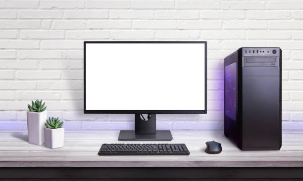 istock Gaming PC on white desk. Isolated screen for mockup. Brick wall in background. 1182084898