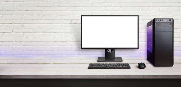 istock Modern gaming computer on desk. Isolated screen for mockup. Copy space beside on brick wall. 1182084919