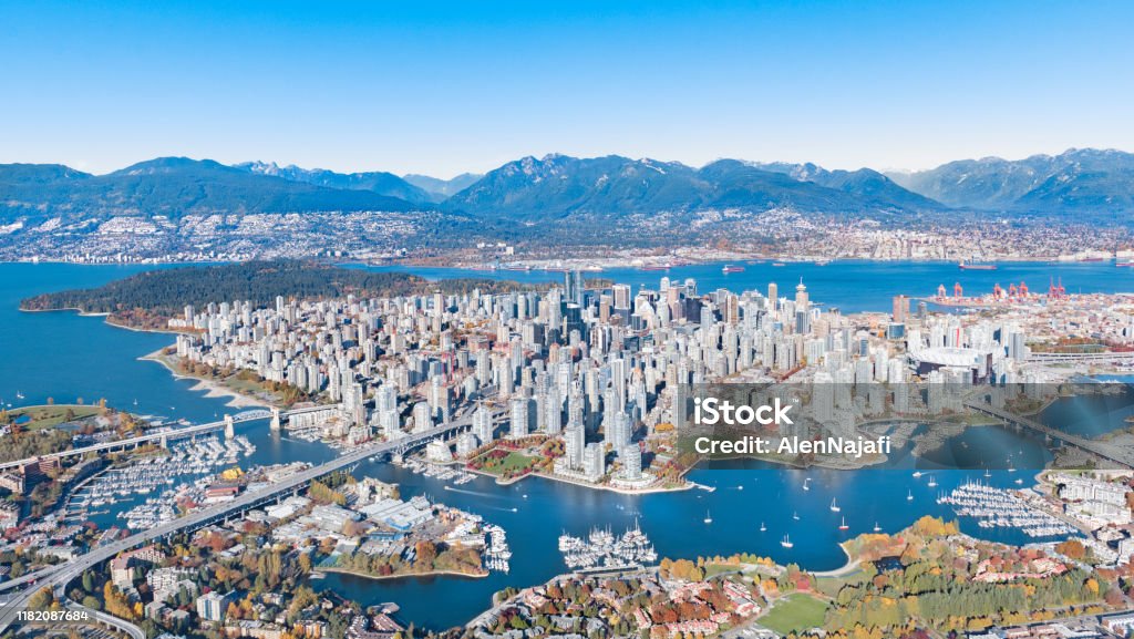 Downtown Aerial View Aerial shot of Downtown Vancouver with Mountains, Skyscrapers, Bridges, burrard inlet in autumn Canada Stock Photo