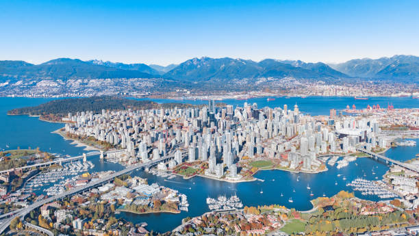 Downtown Aerial View Aerial shot of Downtown Vancouver with Mountains, Skyscrapers, Bridges, burrard inlet in autumn vancouver canada stock pictures, royalty-free photos & images