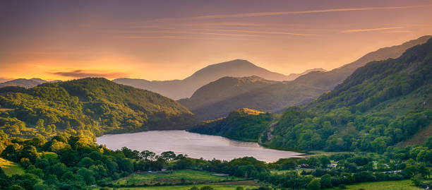 istock The Sun shining through a mountain pass over Llyn Gwynant in Snowdonia 1182089575