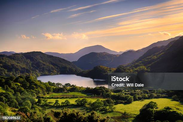 The Sun Shining Across A Mountain And Into Llyn Gwynant In Snowdonia Stock Photo - Download Image Now