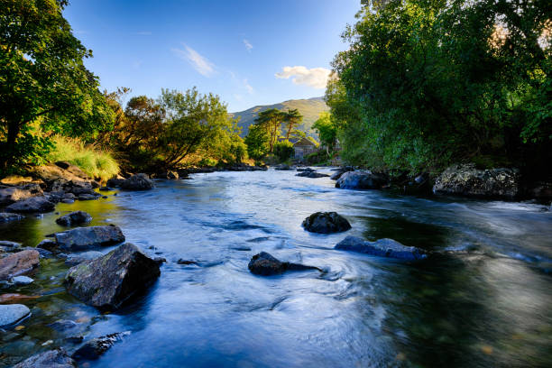 Afon Glaslyn in Snowdonia flowing past the village of Beddgelert Afon Glaslyn in Snowdonia (Eryri), Wales (Cymru), UK, flowing past the village of Beddgelert. snowdonia national park stock pictures, royalty-free photos & images