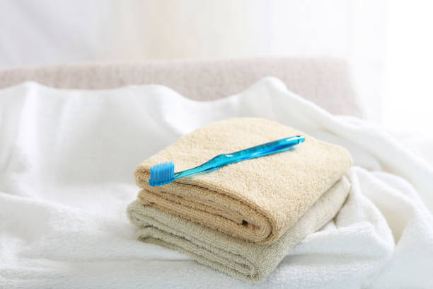 Personal hygiene kit on the white table. Soap,toothbrush, towel, and toothpaste.