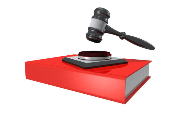 istock Red law book with judge's hammer on white background 1182091169