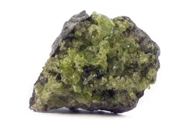 Rock with peridot olivine mineral from the USA isolated on a pure white background