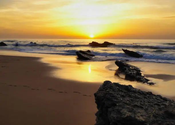 Photo of sunset at the famous beach Praia do Guincho in Portugal