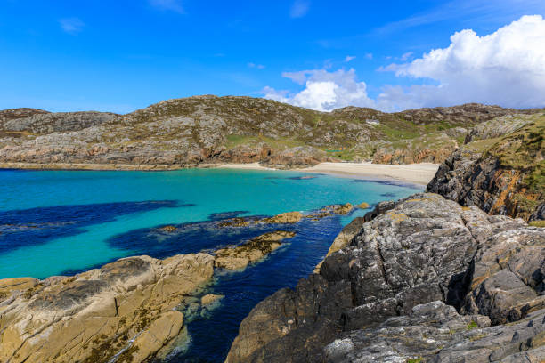 Entrance to Inishbofin Harbour , County Galway, Ireland. Ruins of Cromwell's Barracks guarding the harbour in the distance.