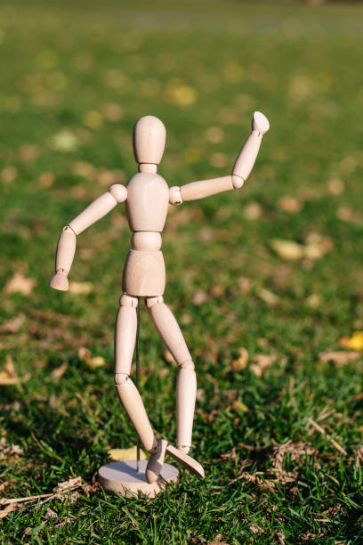 istock Wooden mannequin dancing on a background 1182097847