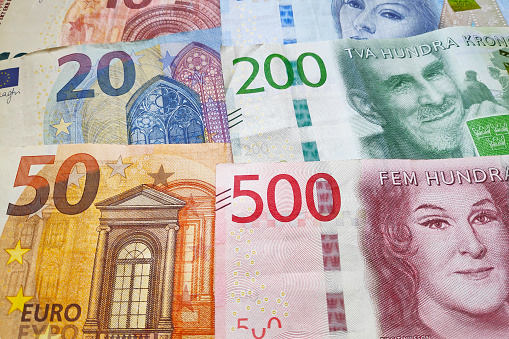 Close-up on a stack of Euros and Swedish Krona.