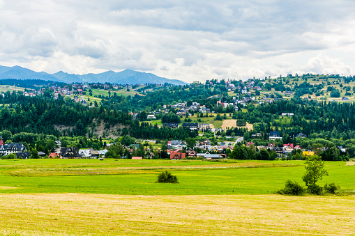 Houses in villages and towns in Podhale in Poland. Tatra peaks visible on the horizon.