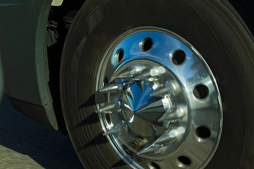 A semi cab sports front chrome wheels with long spike lug nuts