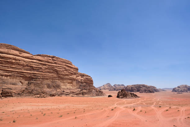 istock 4x4 tracks through the Wadi Rum desert, Jordan (copy space) 1182103235