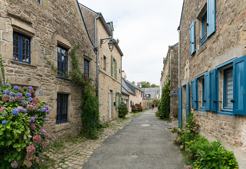 Auray, Morbihan / France - 25 August 2019: older couple walks through the narrow streets of an idyllic French village