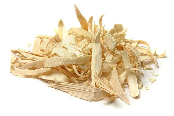 An isolated pile of wood shavings from wood working, whittling, etc. Isolated on white.