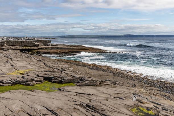 istock Lighthouse  and cliffs of Moher in background in Inisheer island 1182111463