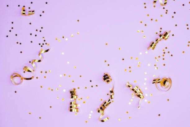 istock Golden decorations and sparkles on pale purple background 1182113644
