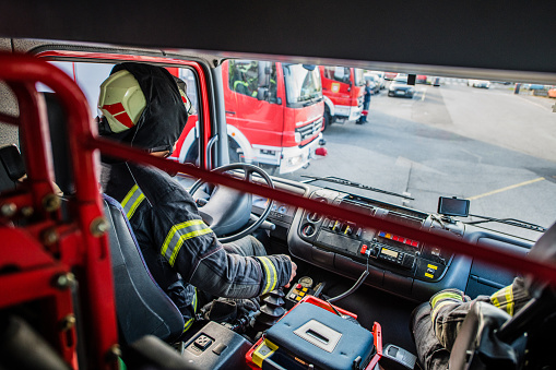Firefighter in a fire truck; all logos removed. Slovenia, Europe. Nikon.