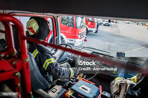 istock Firefighter driving a fire truck Top View 1182117187