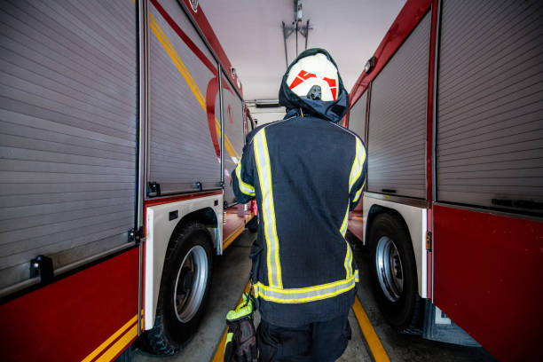 istock Firefighter back view running into the Fire truck 1182117389