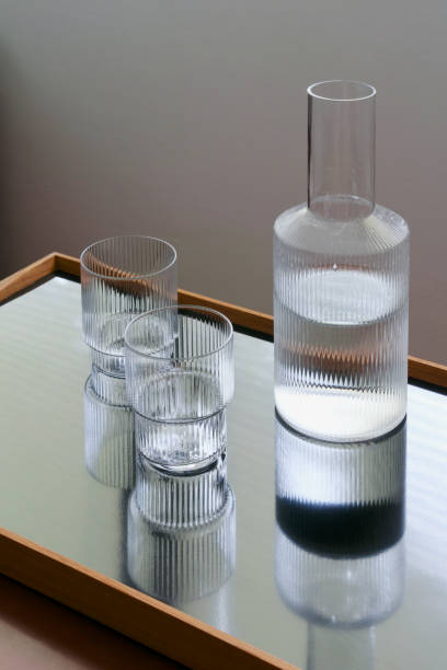 istock Two glasses and carafe with water 1182120301