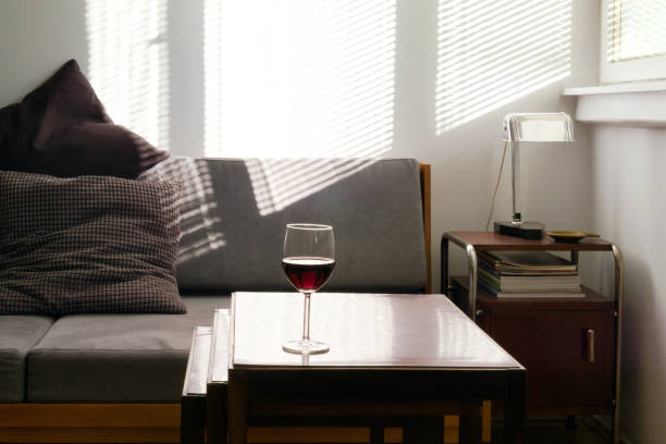 istock Home interior with glass of wine on nesting tables 1182121133