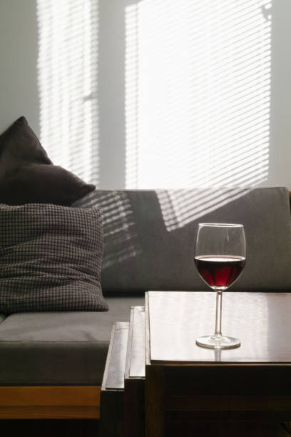 istock Glass of red wine on table 1182121264